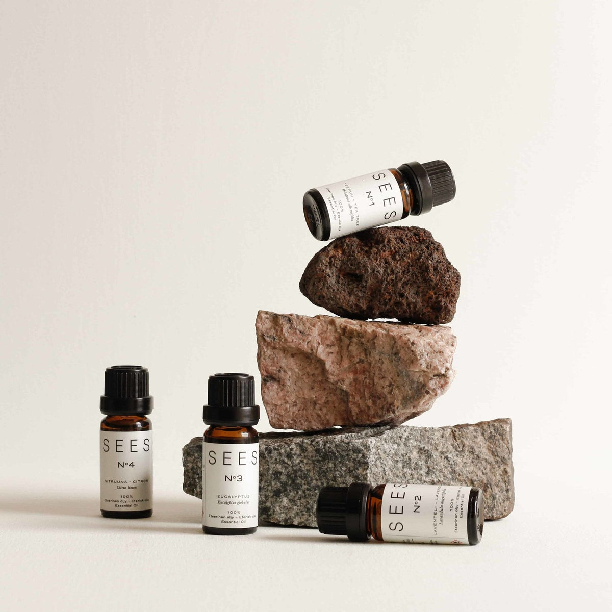SEES essential oils arranged on and around natural stones
